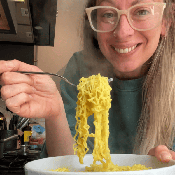 Blog post author Sarah Howells eating a bowl of gluten free noodles.