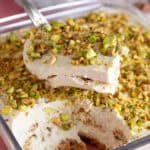 A gluten free pistachio tiramisu with a portion taken out of it, showing the layers.