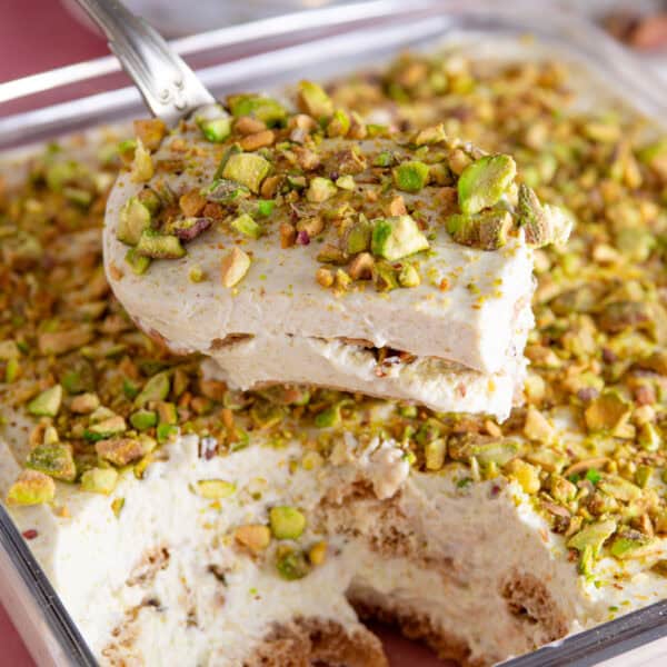 A gluten free pistachio tiramisu with a portion taken out of it, showing the layers.