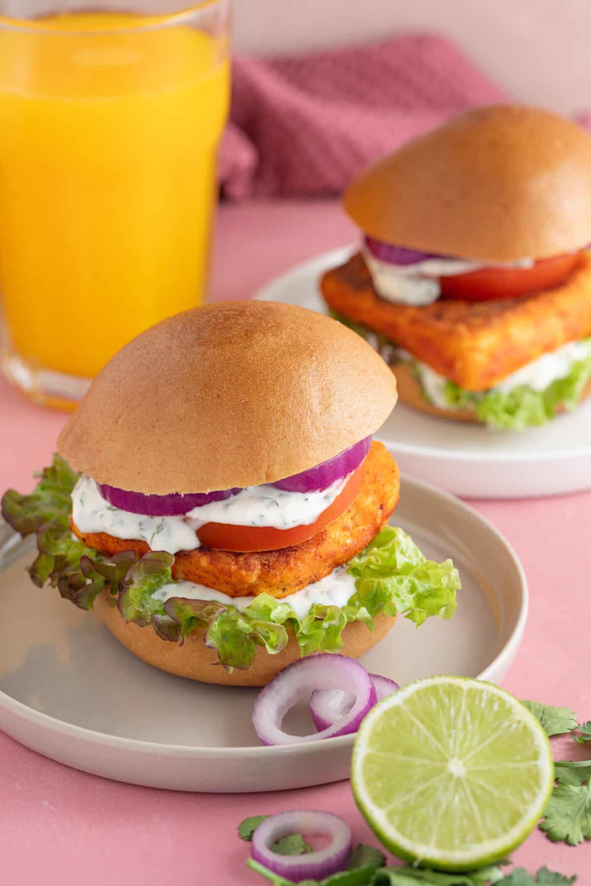 A crispy halloumi burger with red onion, salad, lime mayo and a burger bun.