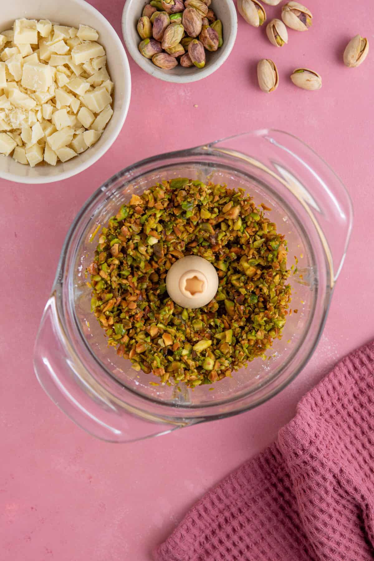 Process shot for pistachio spread recipe showing the pistachio kernels in a food processor.