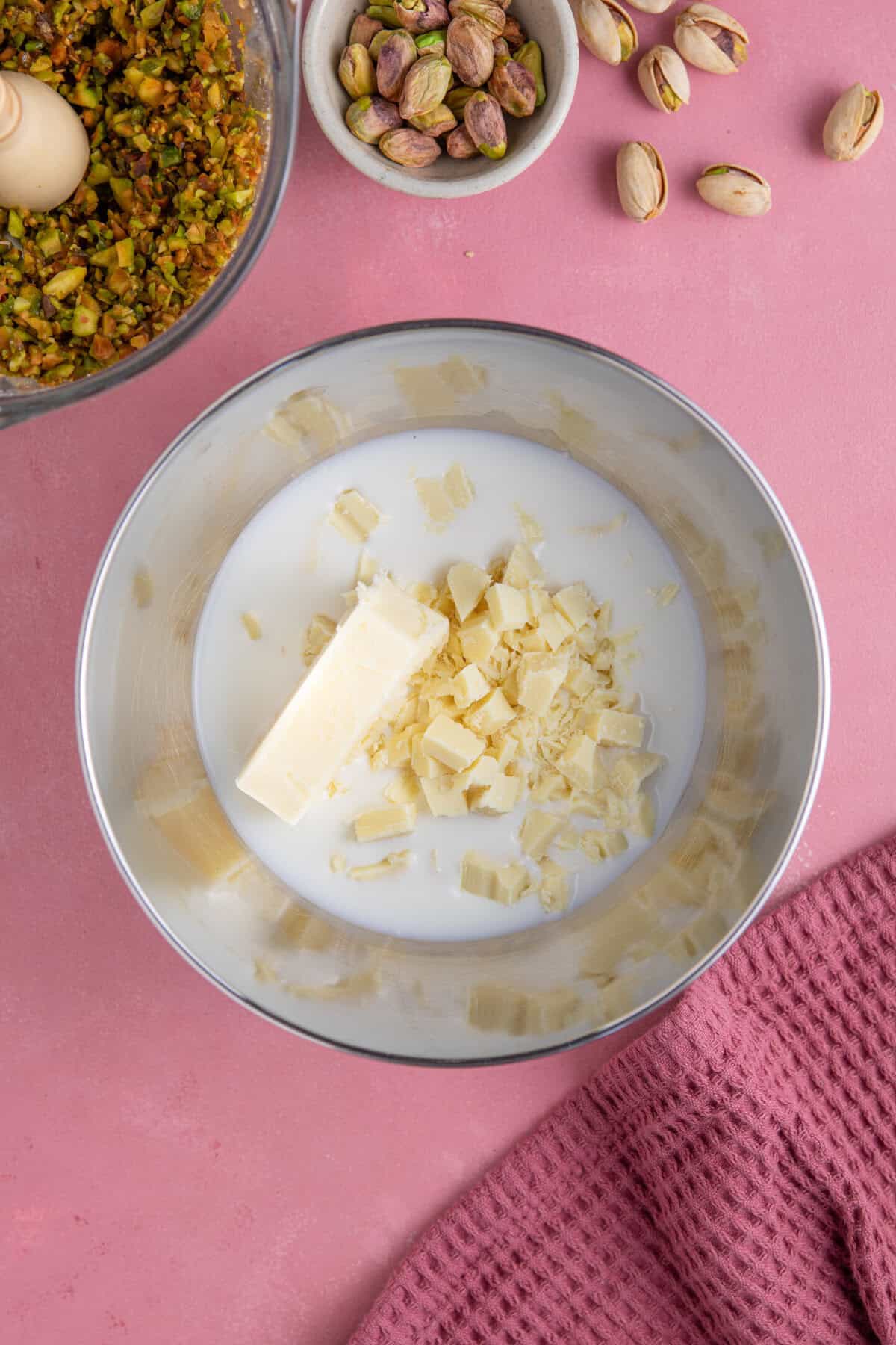 Process shot for pistachio spread recipe showing the butter, white chocolate and milk in a pan ready to melt.