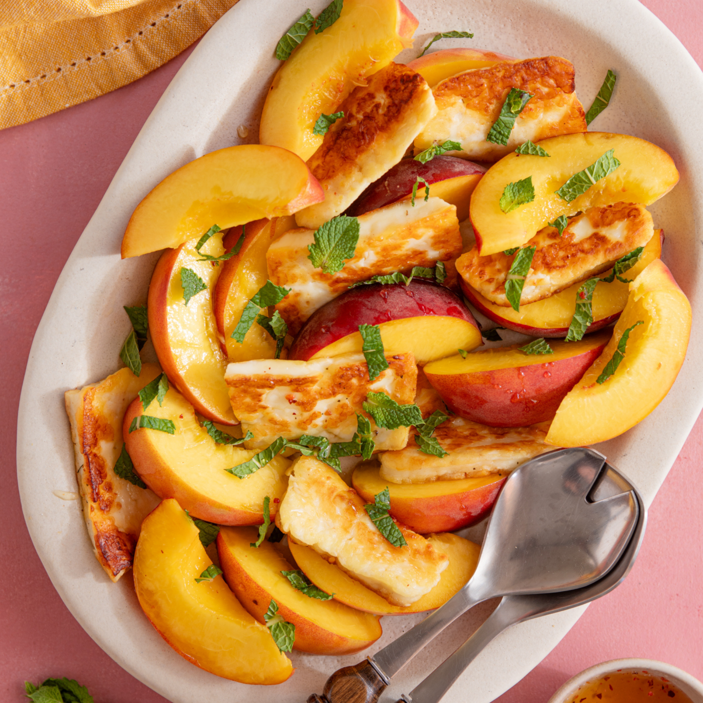 Close up of a bowl of peach and halloumi salad.
