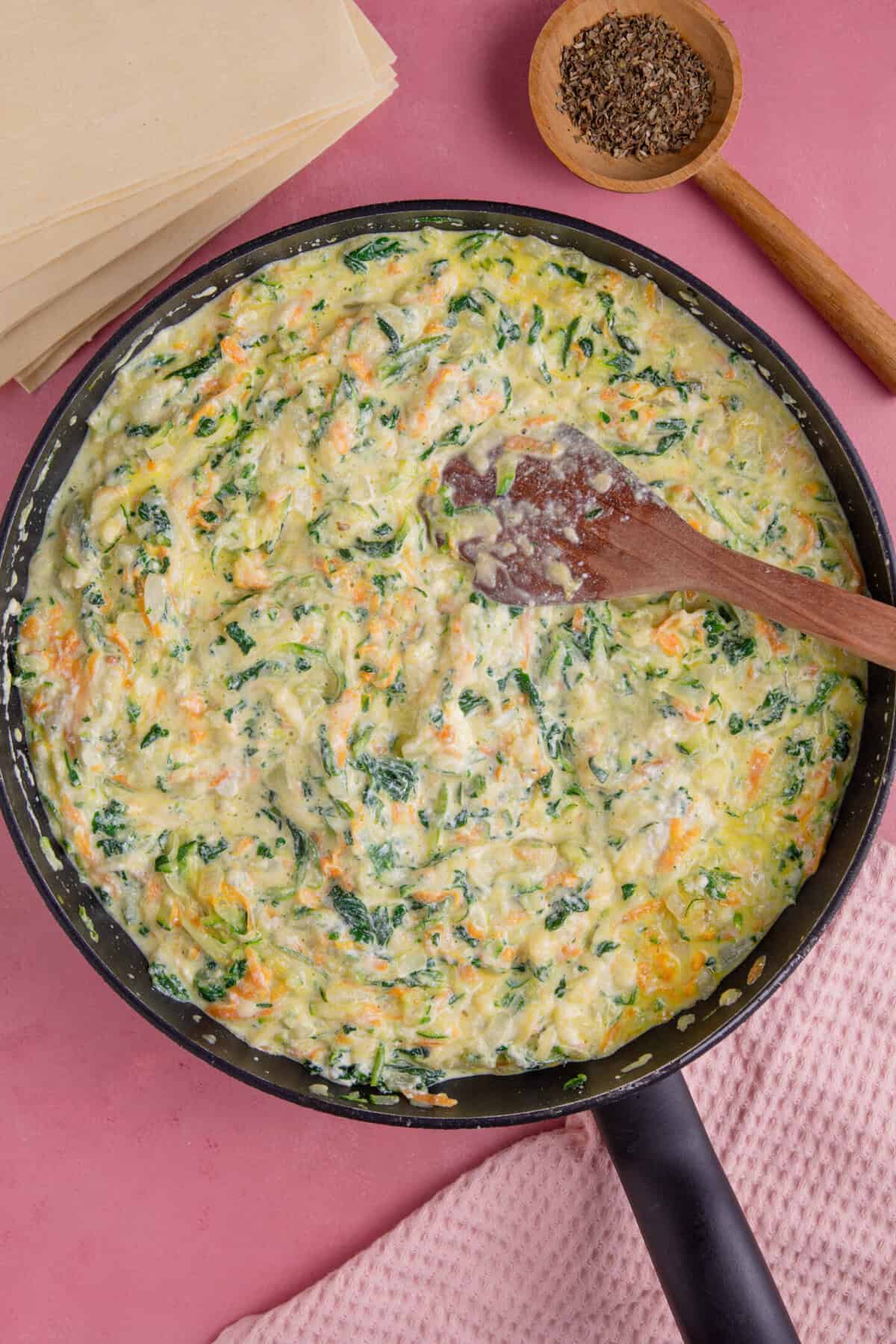 Gluten free courgette lasagne recipe process shot showing the finished cheese sauce layer.