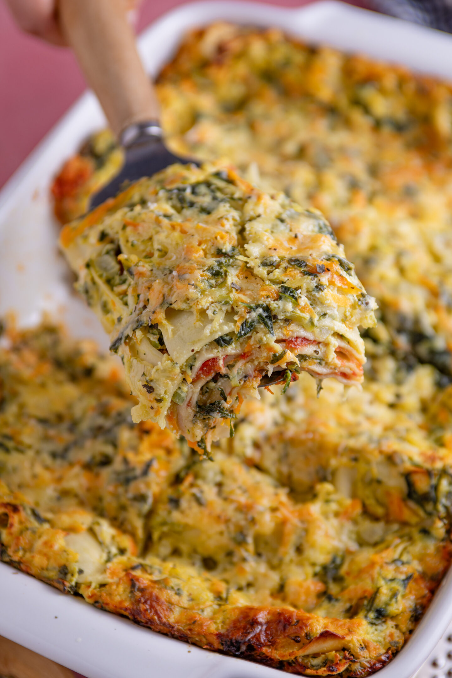 A slice of gluten free courgette lasagne with layers of courgette and ricotta.