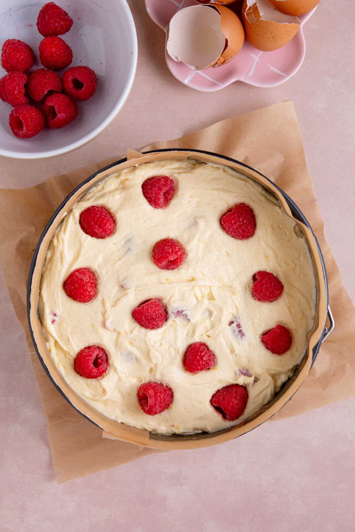 Pour the cake batter into the tin, top with the extra raspberries and bake.