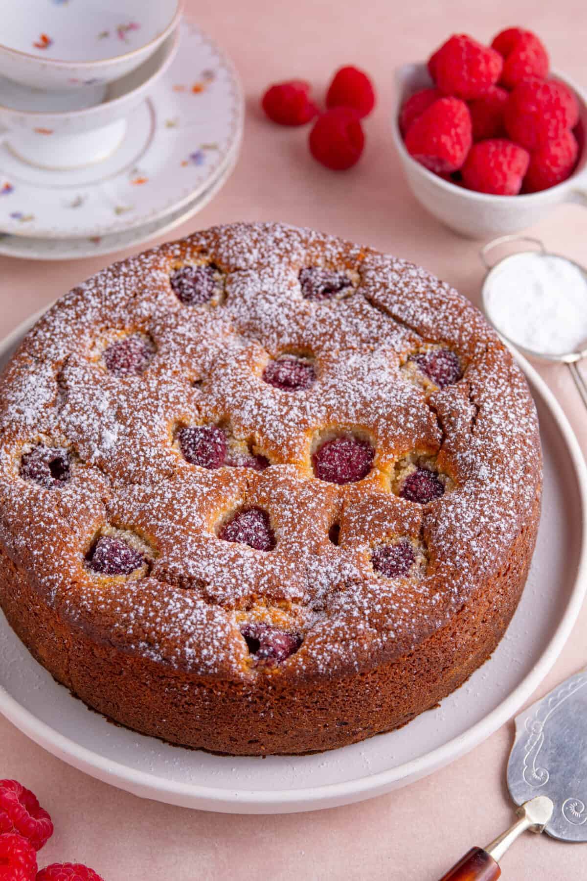 A gluten free ricotta and raspberry cake  on a plate.