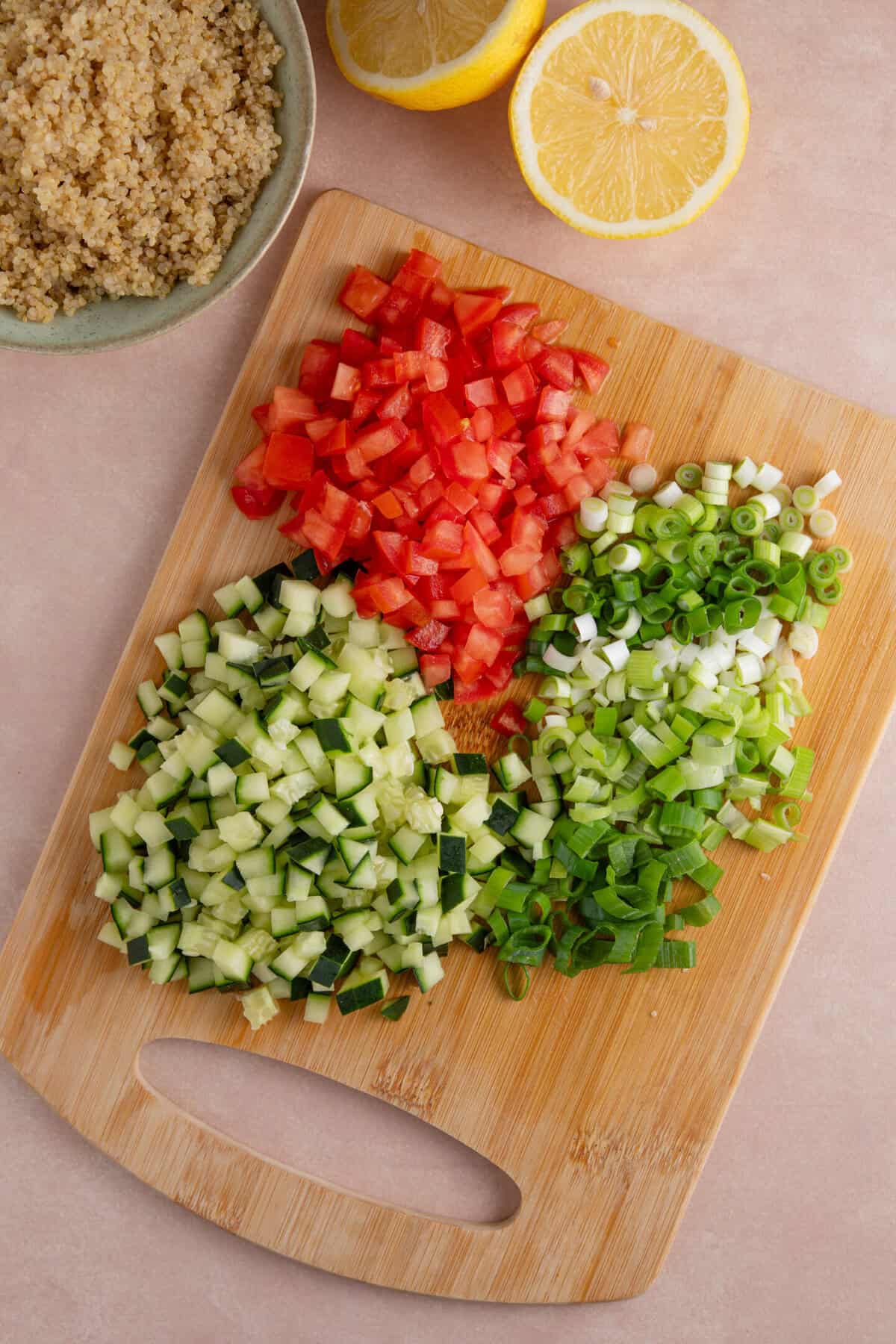 Process shot of gluten free tabbouleh recipe showing the finely chopped tomato, cucumber and spring onions.