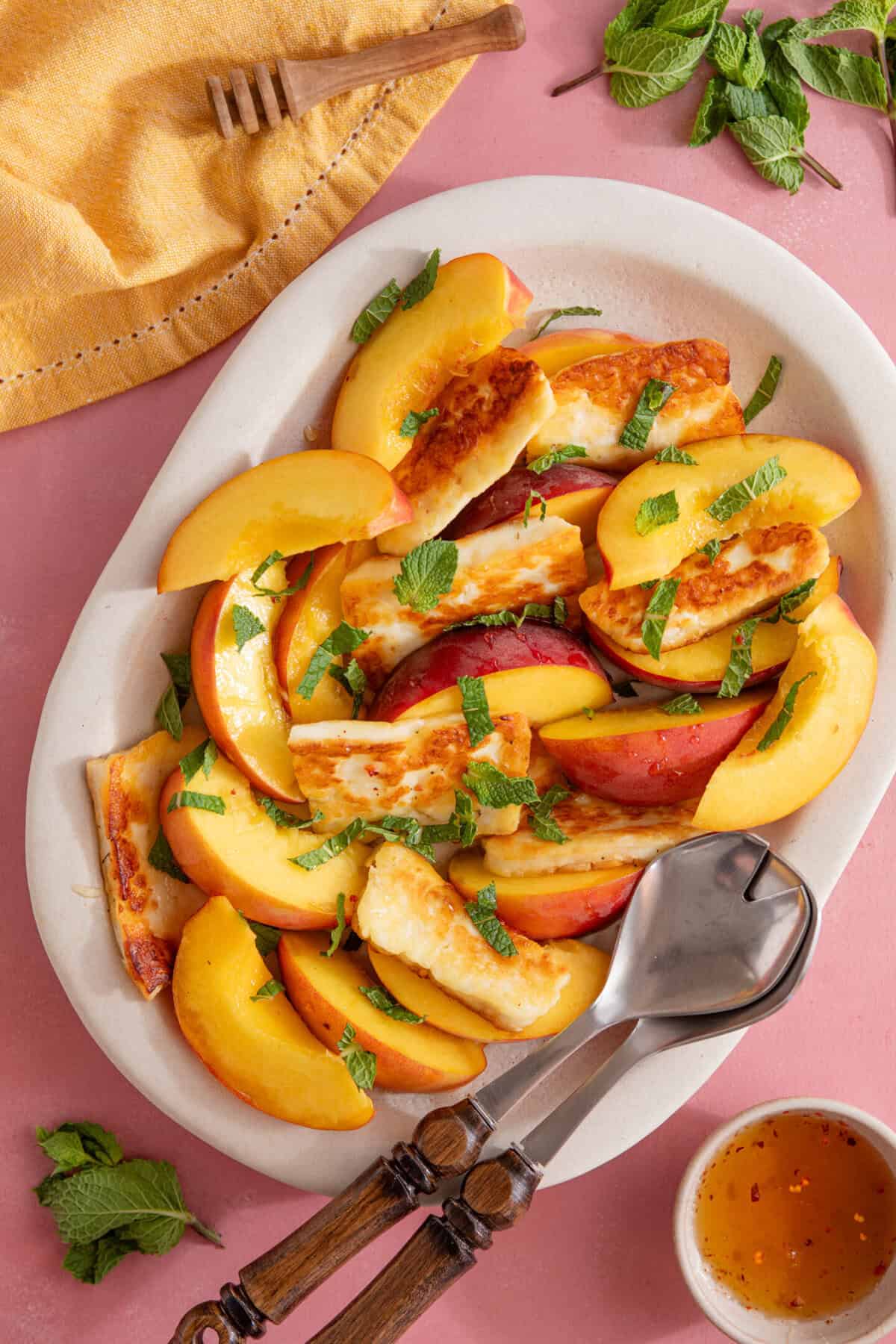 Process shot of peach and halloumi salad recipe showing the finished salad in a serving dish.