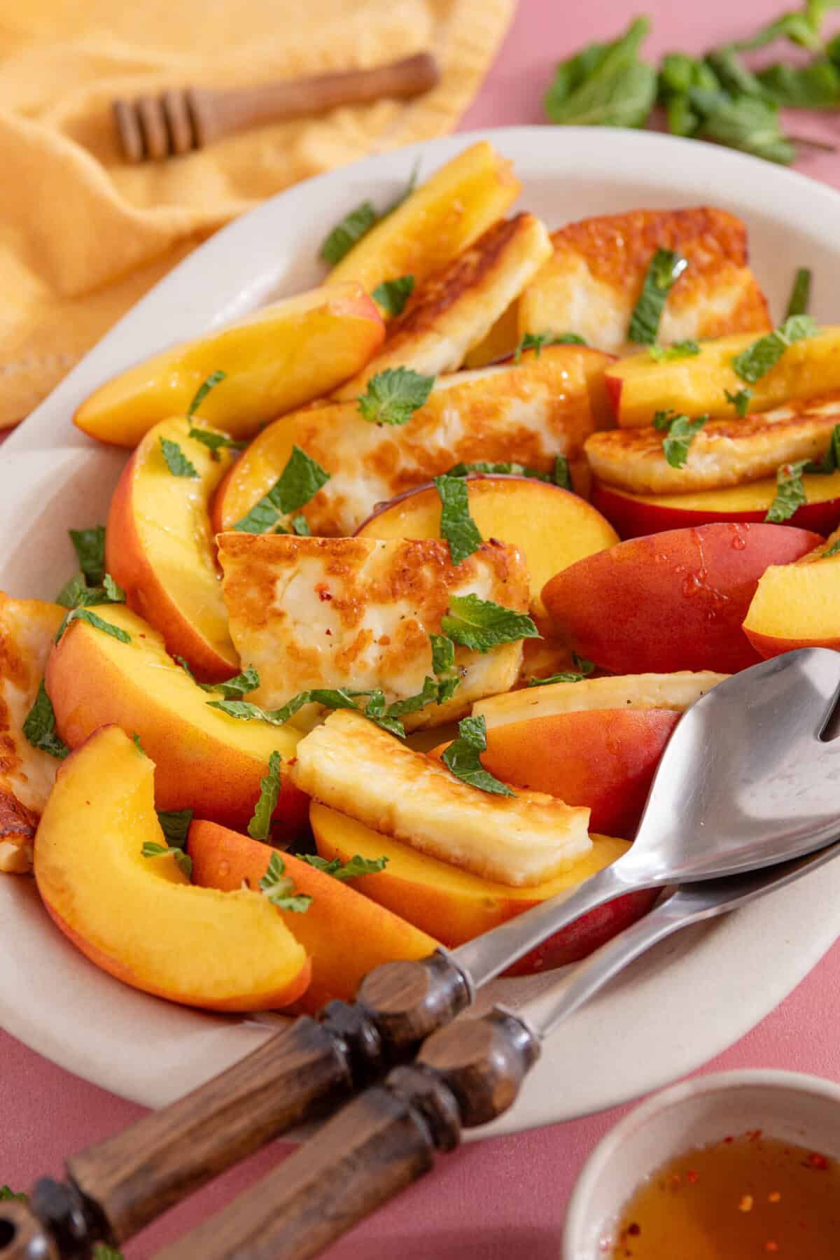Close up of a bowl of peach and halloumi salad.