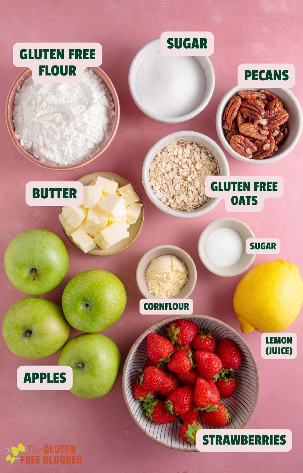 Ingredients for a gluten free strawberry and apple crumble with text labels.