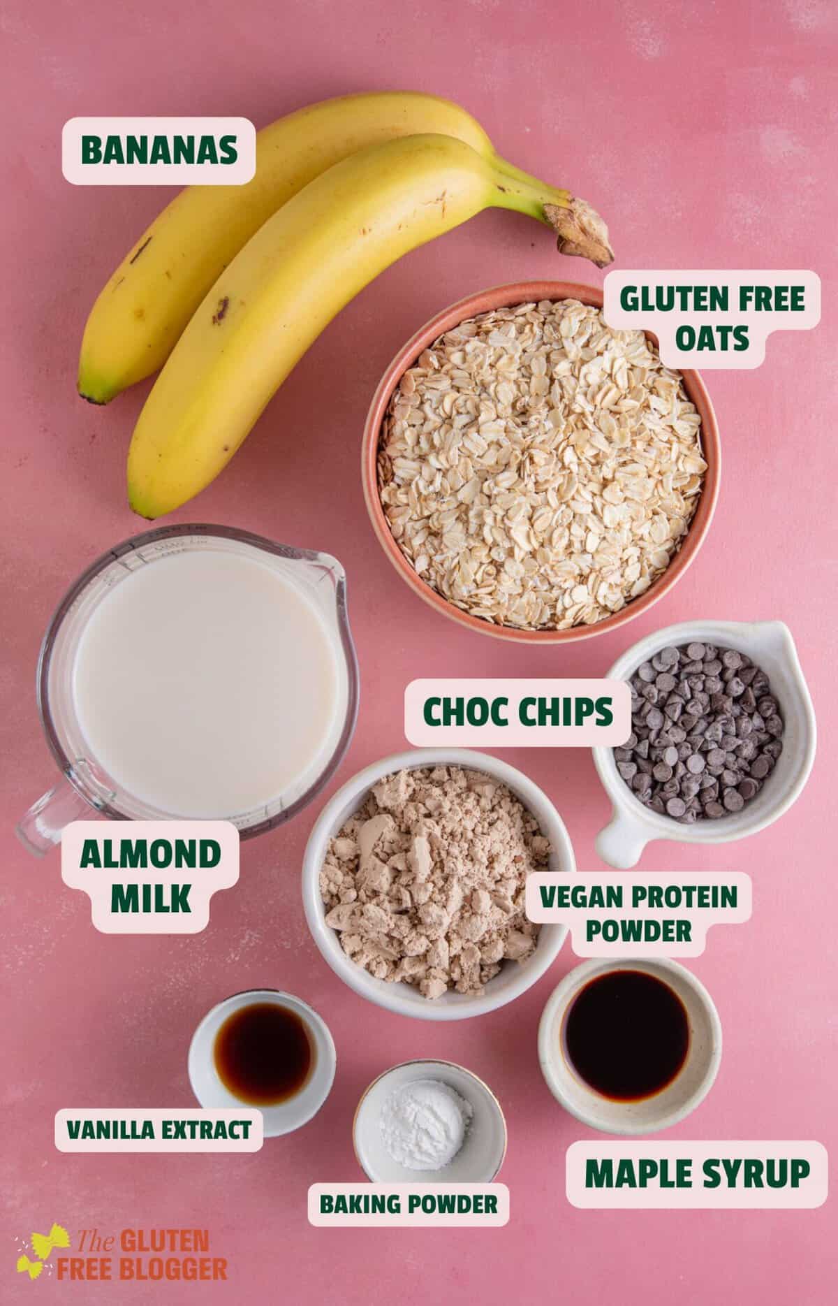 Ingredients for banana baked protein oats with text labels including bananas, oats, chocolate chips and almond milk.