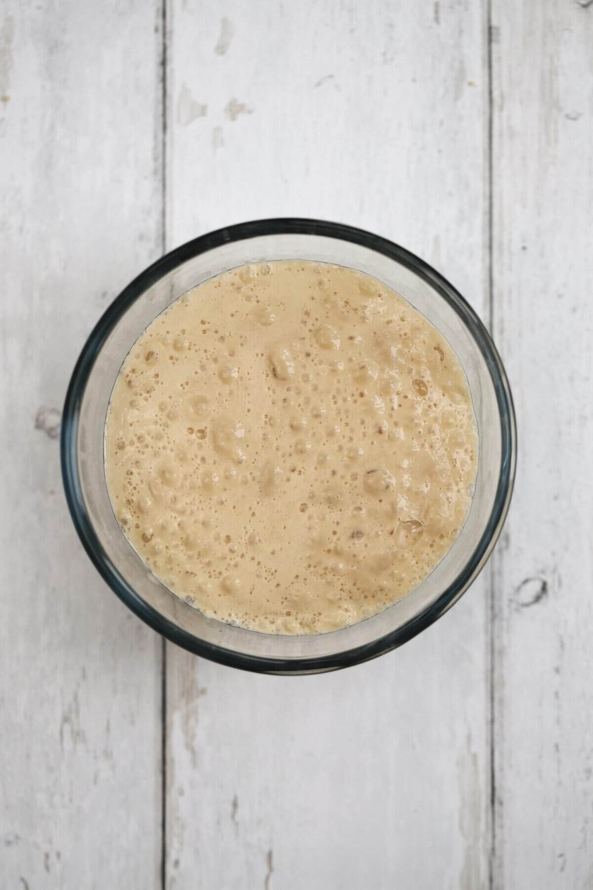 Process shot of 5-ingredient gluten free bread recipe showing the yeast activated in warm water.