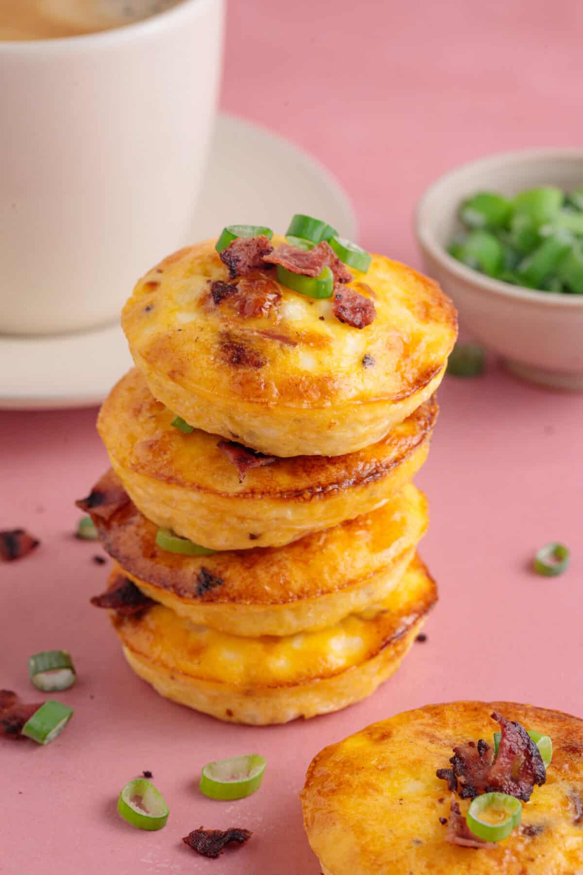 A stack of cottage cheese egg muffins with bacon, cheese and chives.
