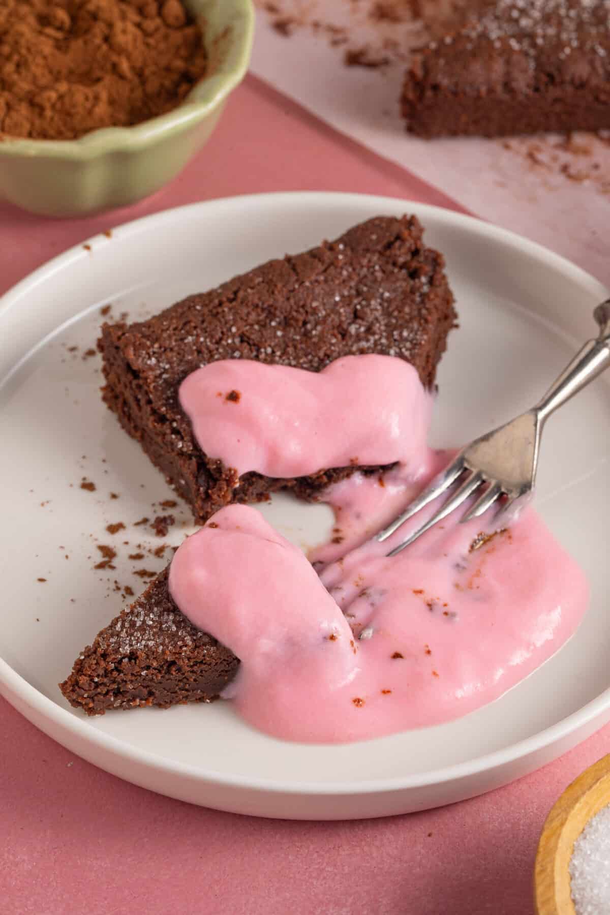 A slice of chocolate concrete with pink custard.