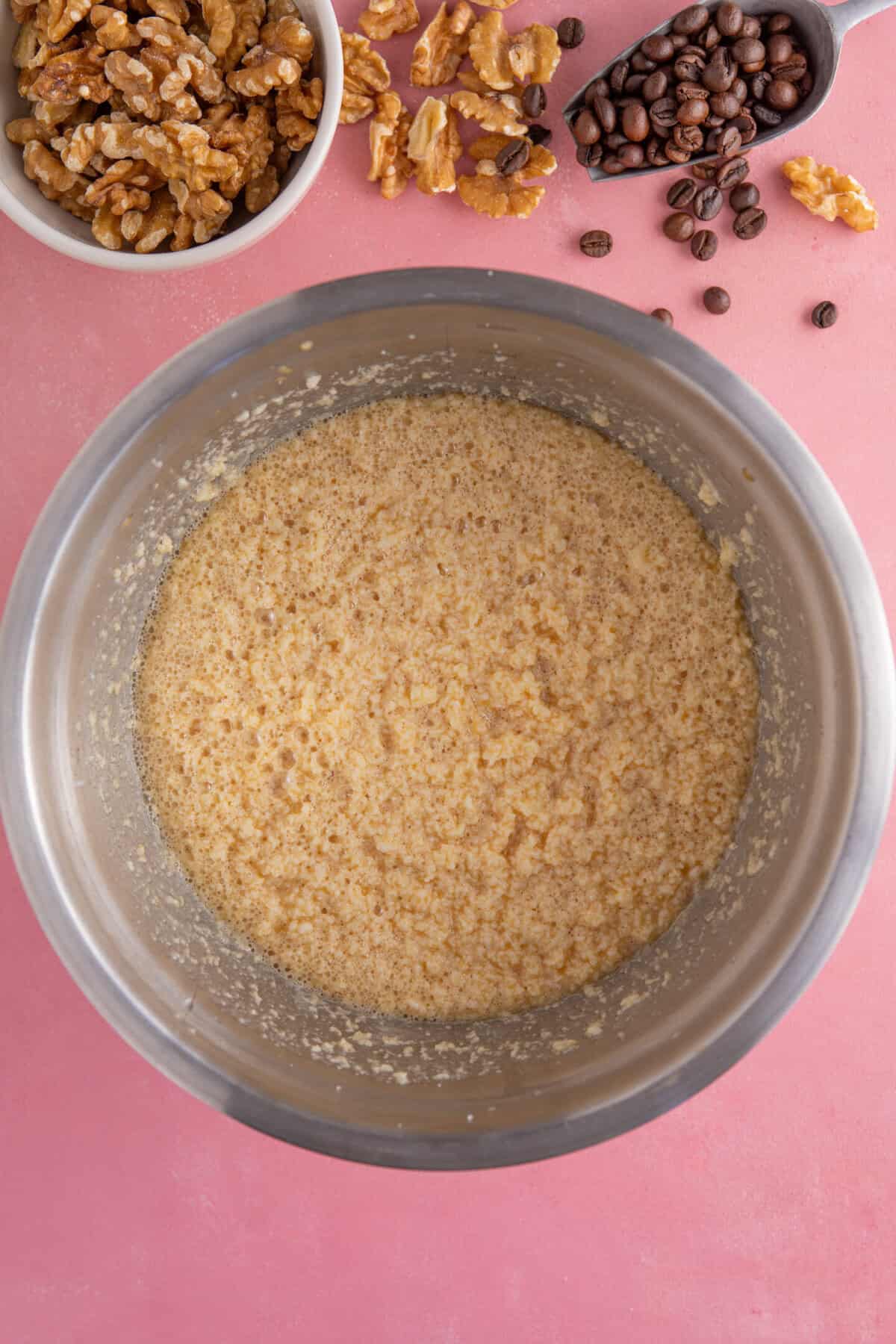 Process shot for gluten free coffee and walnut cake showing the wet cake mix ingredients.