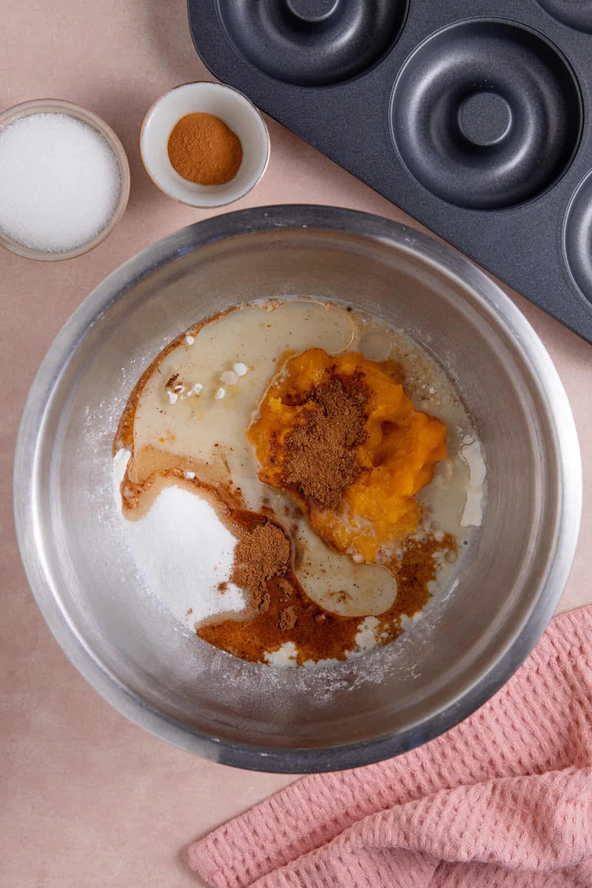 Process shots for gluten free pumpkin donuts recipe showing the wet ingredients mixed together.