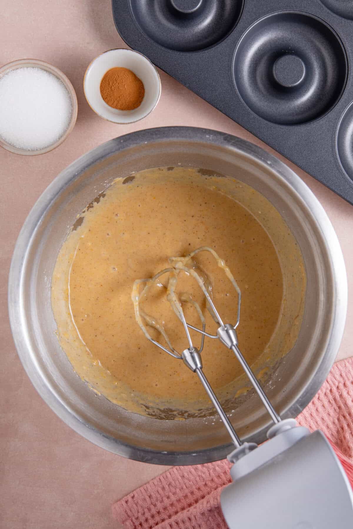 Process shots for gluten free pumpkin donuts recipe showing everything mixed together.