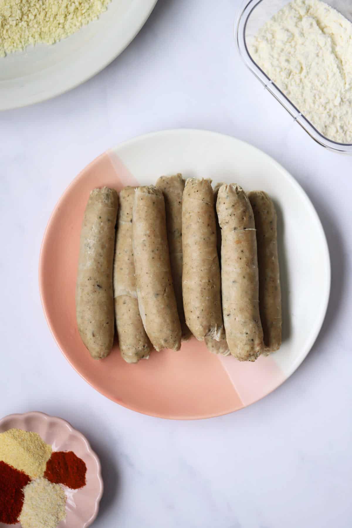 Process shot of gluten free turkey twizzlers showing a plate of boiled turkey sausages.