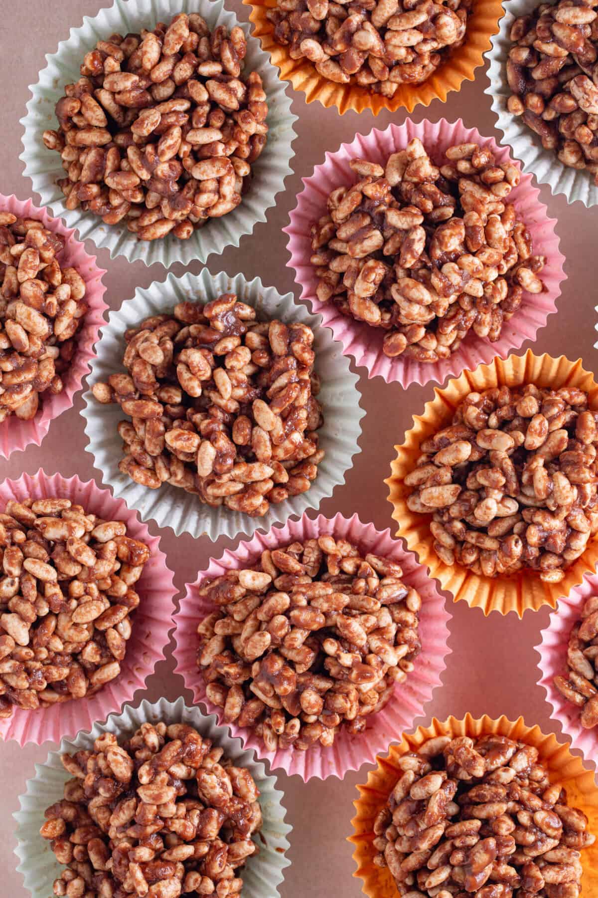 Overhead shot of chocolate rice crispy cakes in different coloured cake cases.