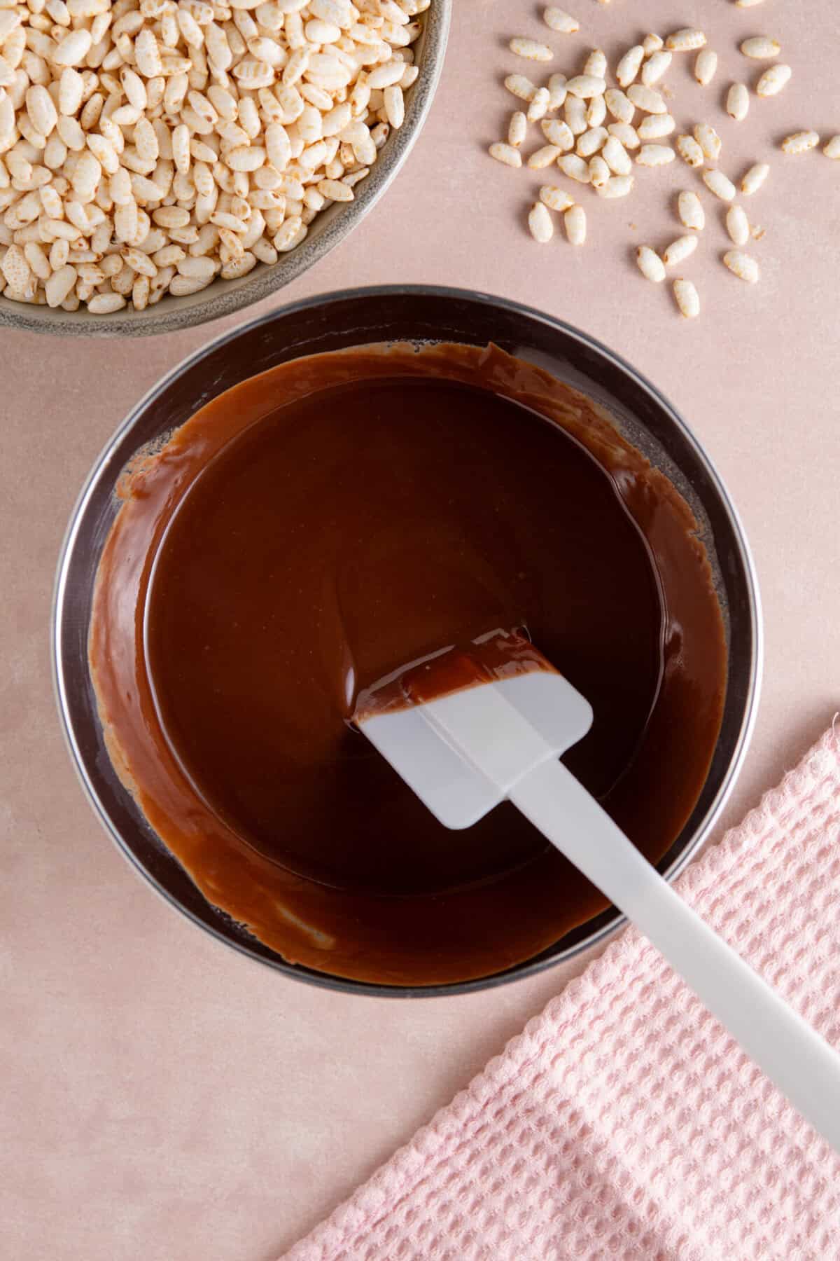 A metal bowl filled with melted chocolate.