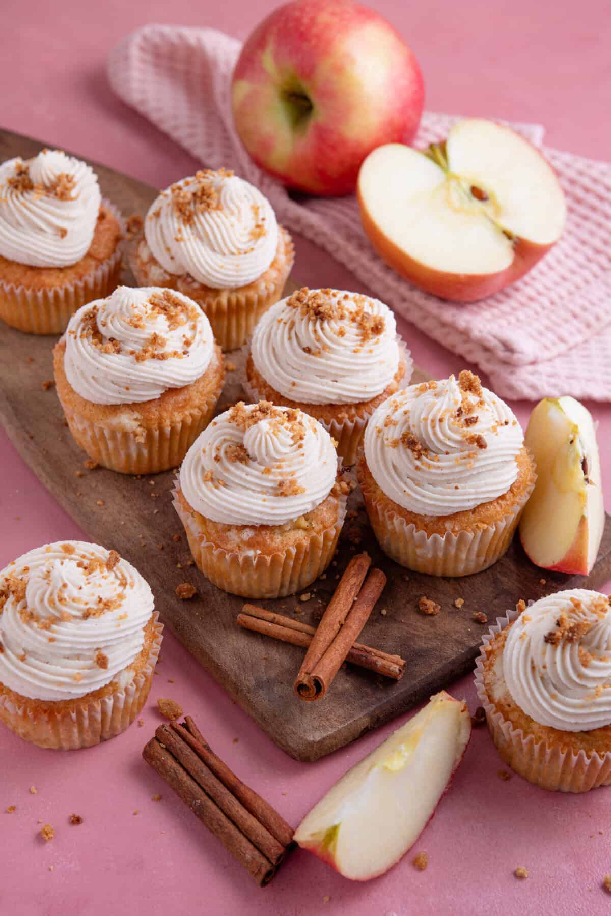 Process shot of gluten free apple crumble cupcakes showing the finished cupcakes decorated with frosting and crumble pieces.