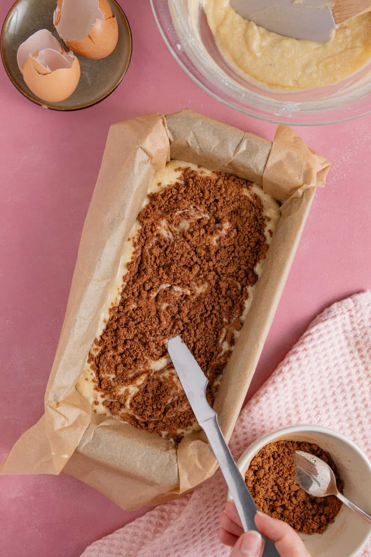 Process shot of cinnamon swirl banana bread showing the cinnamon layer on the banana bread batter.