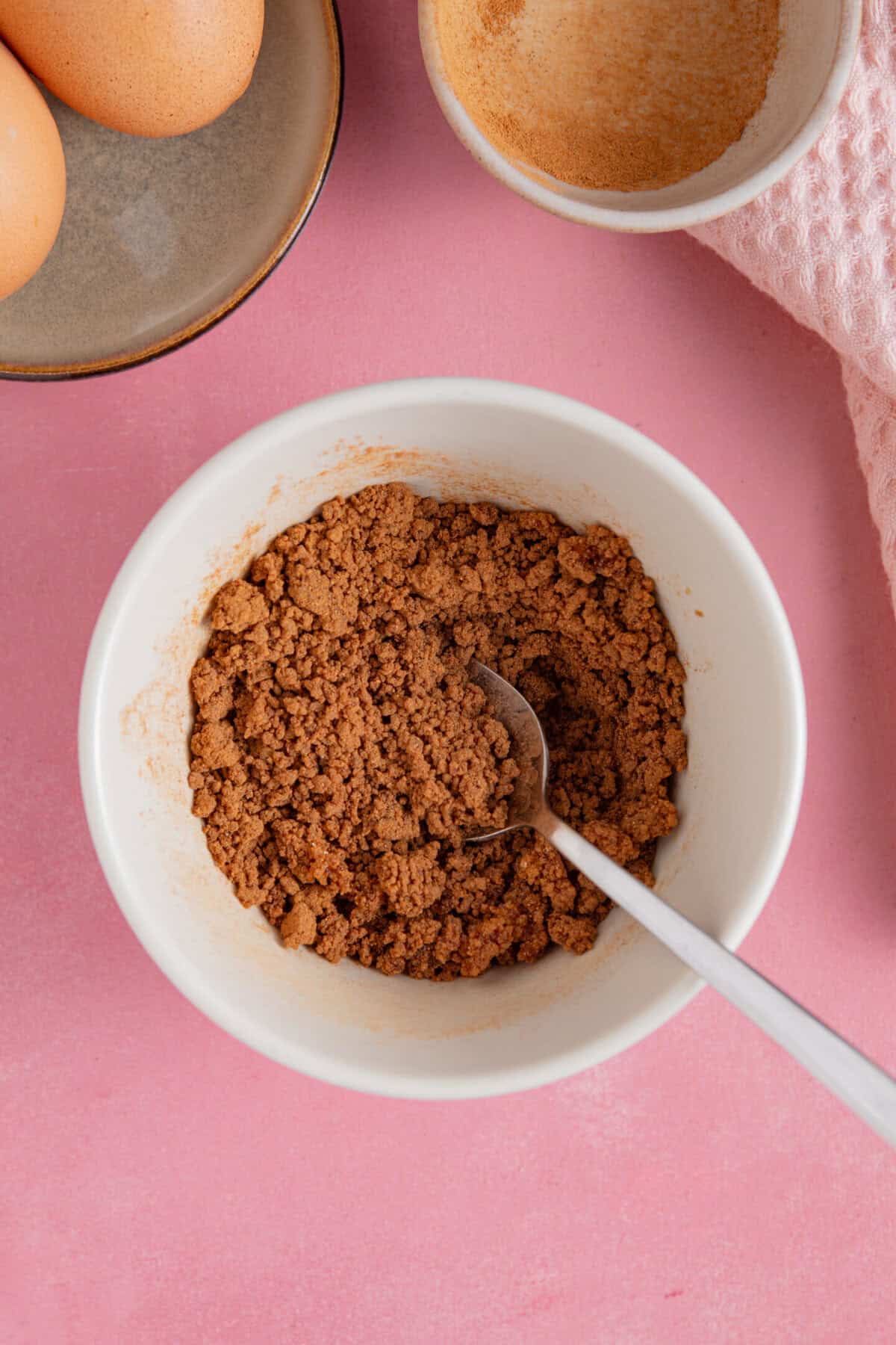 Process shot of cinnamon swirl banana bread showing a bowl of brown sugar and cinnamon mixed together.
