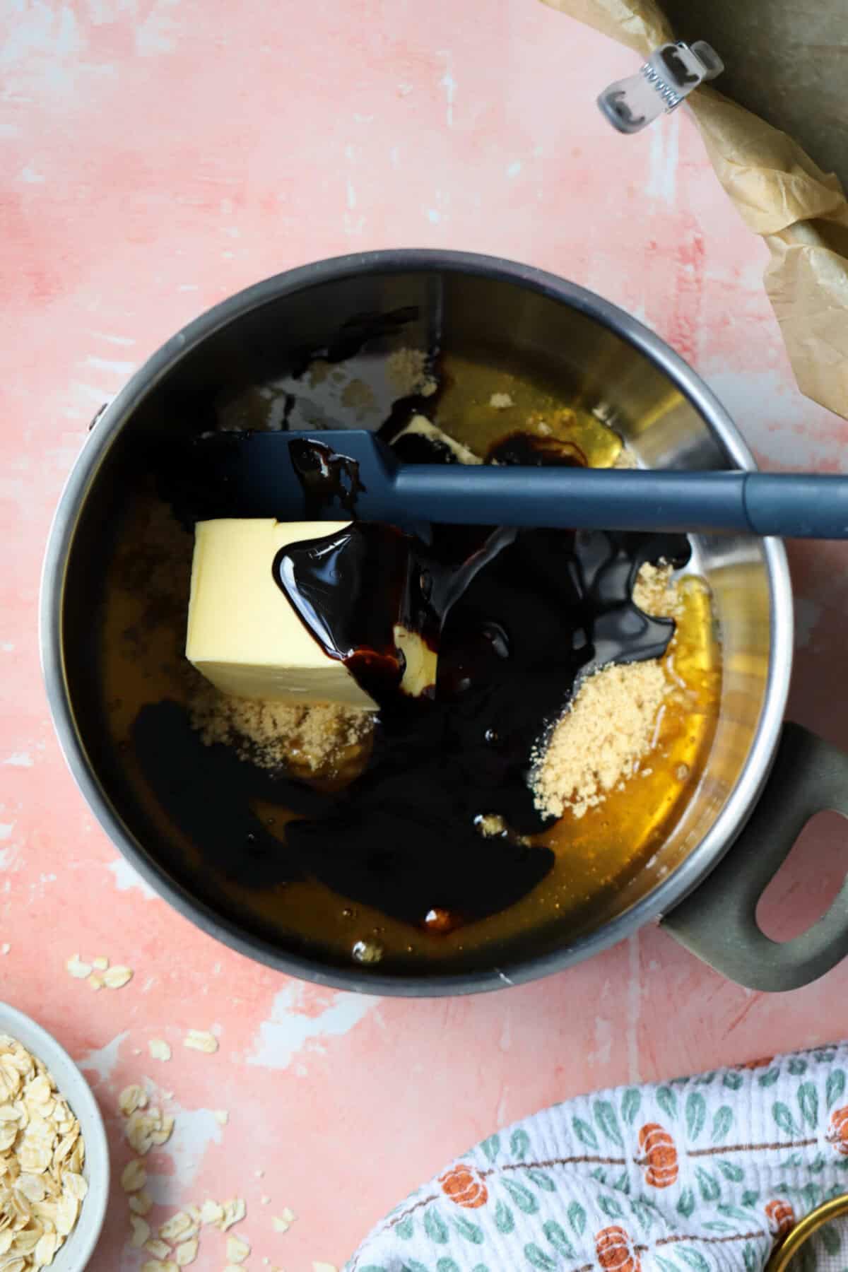 Process shot for gluten free parkin recipe showing the butter, treacle, sugar and syrup in a pan.