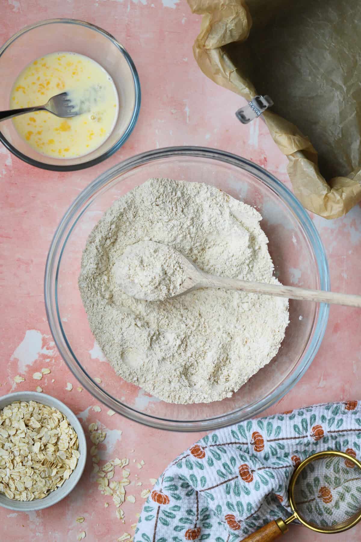 Process shot for gluten free parkin recipe showing a bowl of flour and spices mixed together.