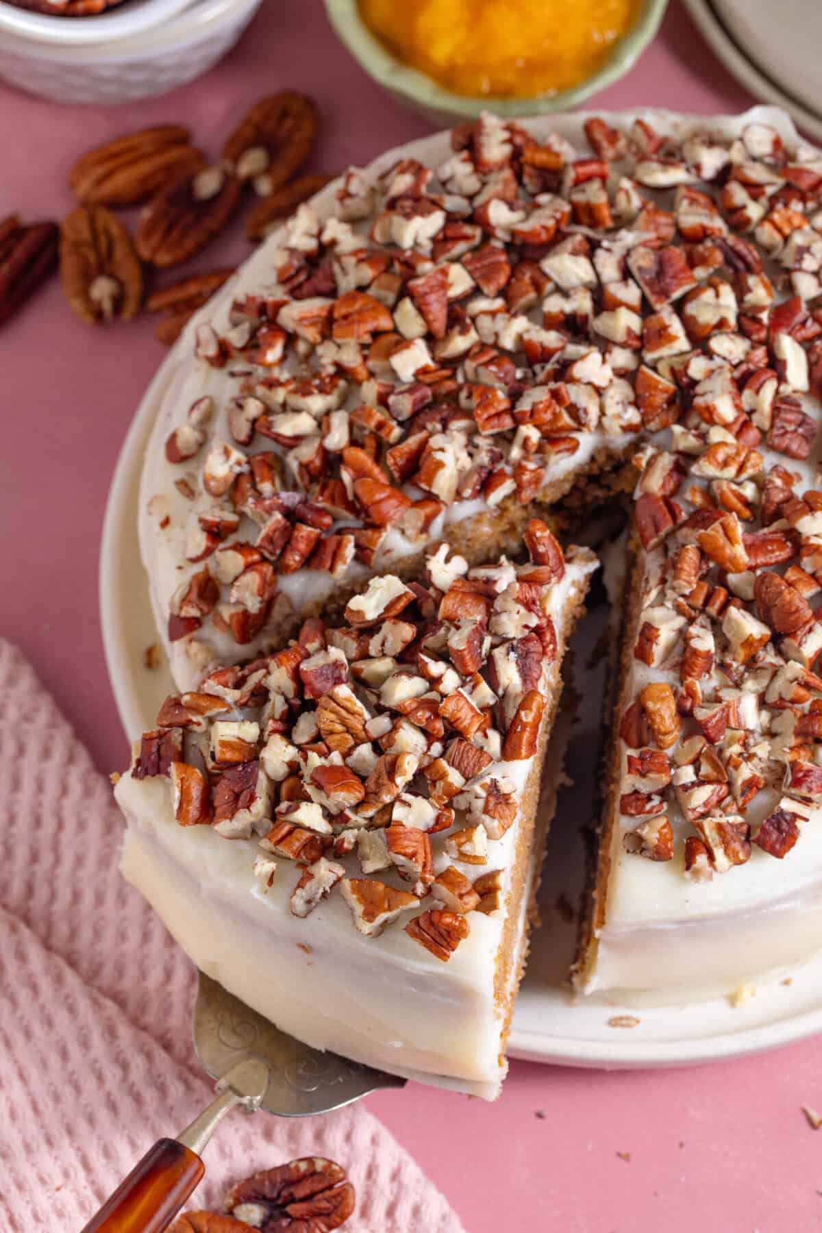 A gluten free pumpkin spice latte cake with a slice cut out.