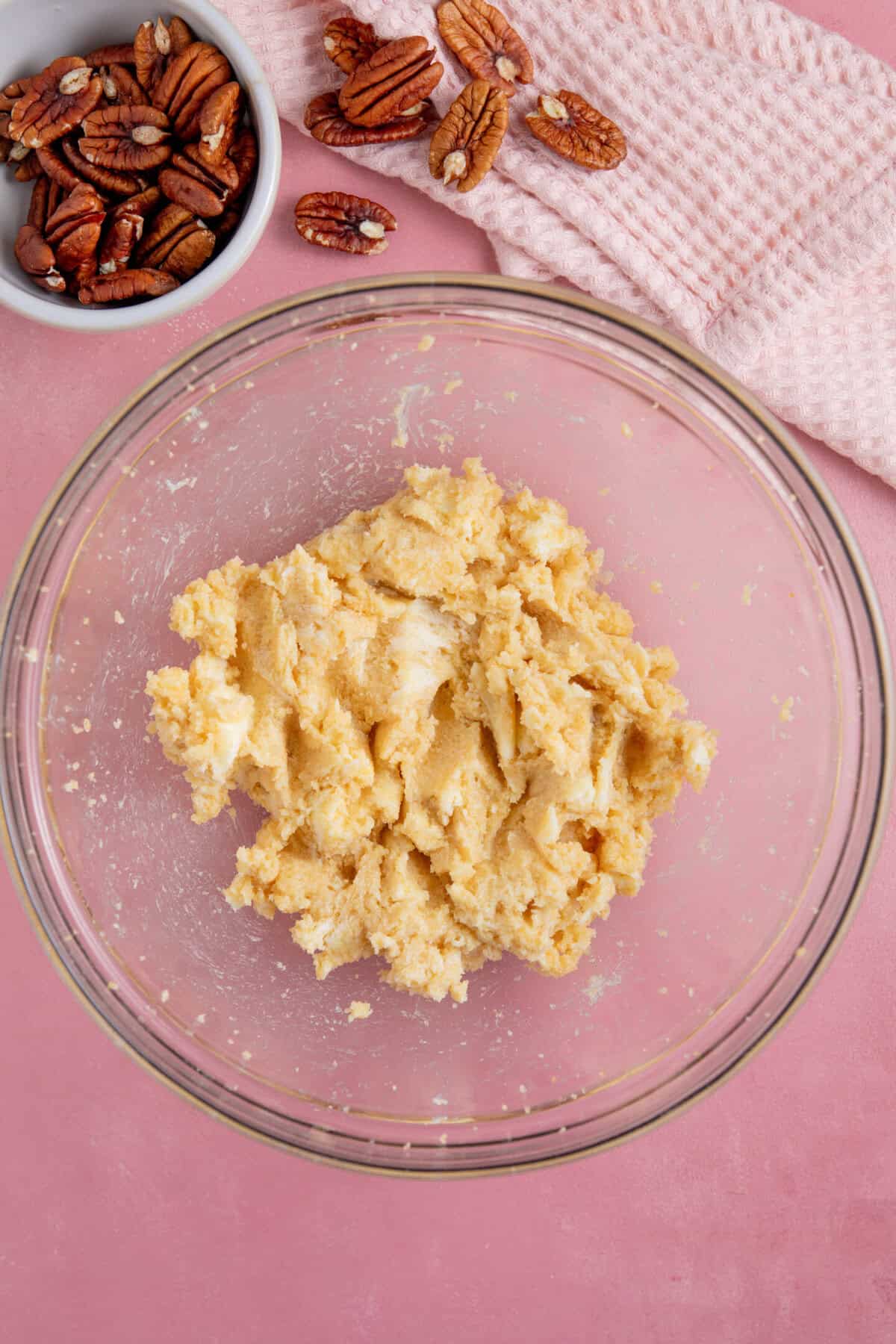 Process shot for a pumpkin spice latte cake showing the butter and sugar creamed together in a glass mixing bowl.