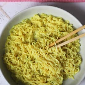 A bowl of gluten free chicken super noodles with chopsticks.