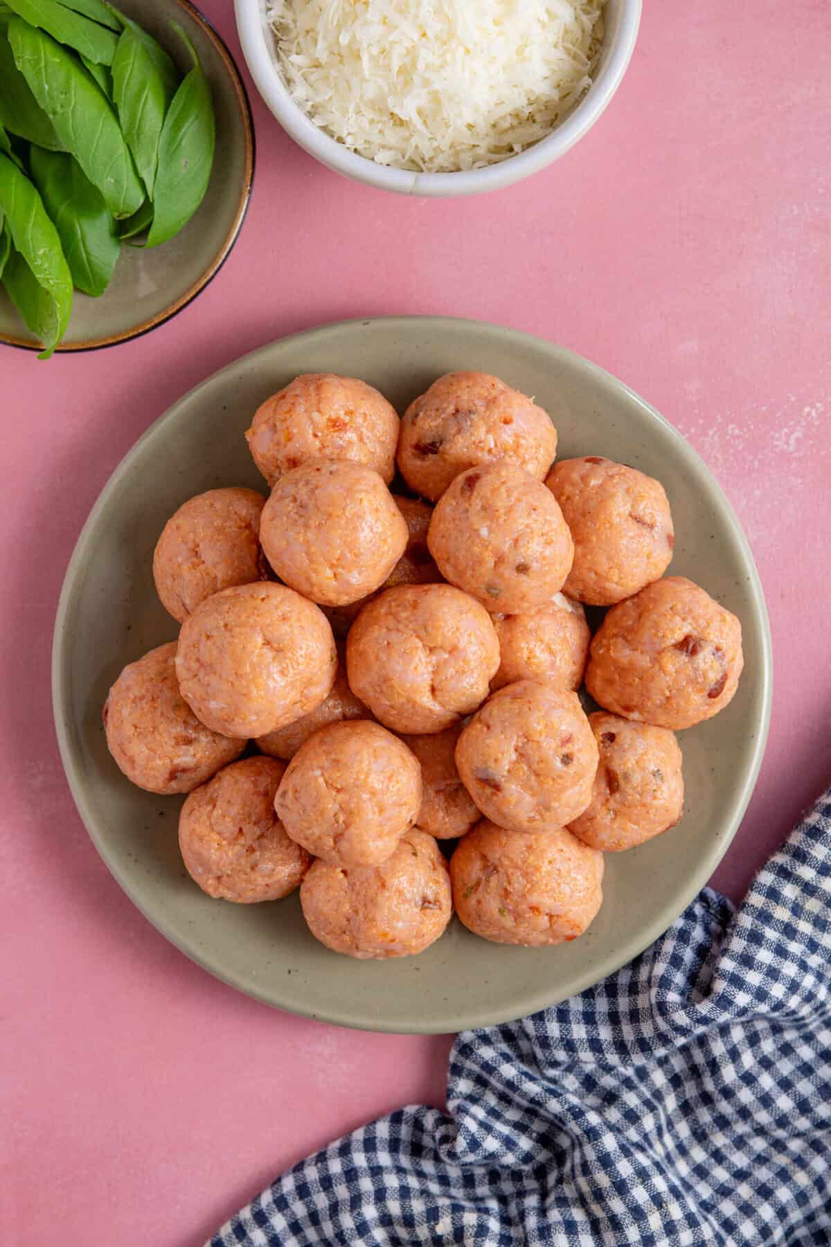 Process shot for Marry Me Chicken Meatballs showing the raw meatballs on a plate.