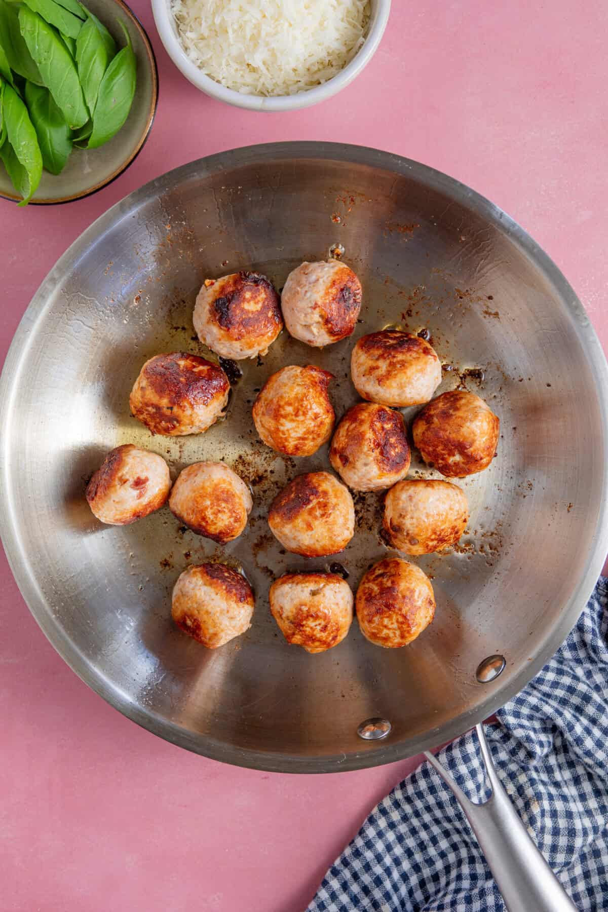 Process shot for Marry Me Chicken Meatballs showing the browned meatballs in a pan.