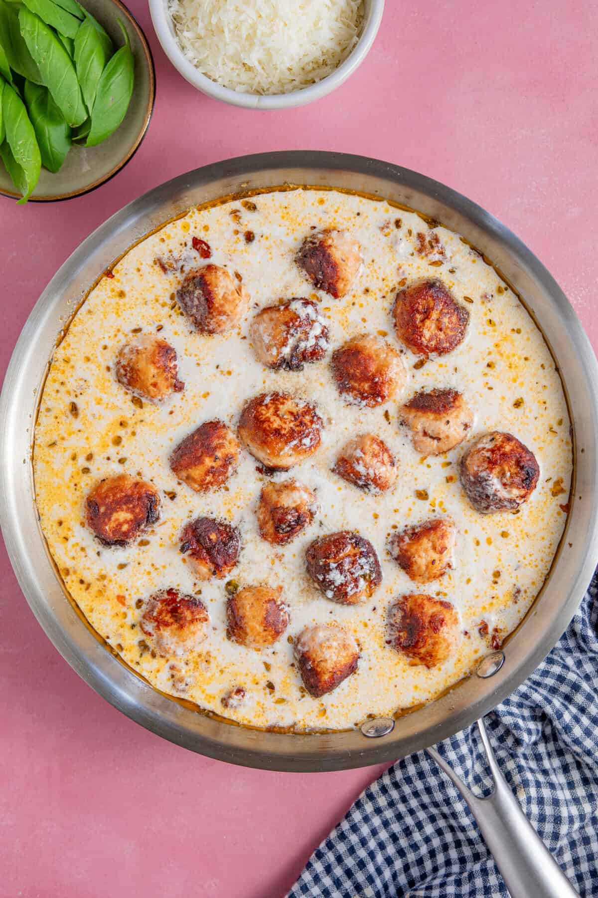 Process shot for Marry Me Chicken Meatballs showing the sauce and meatballs in a pan.