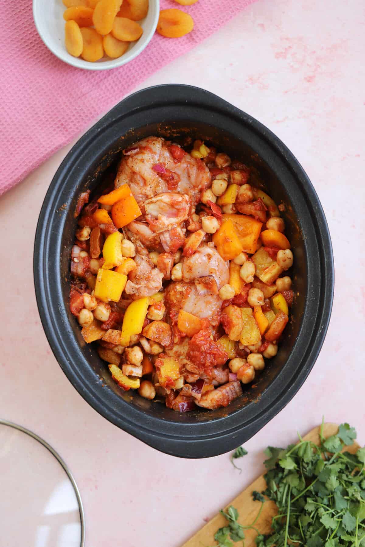 Process shot for slow cooker chicken tagine showing everything mixed together in the slow cooker.