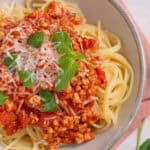 A bowl of turkey bolognese sauce served on top of gluten fre4e spaghetti.
